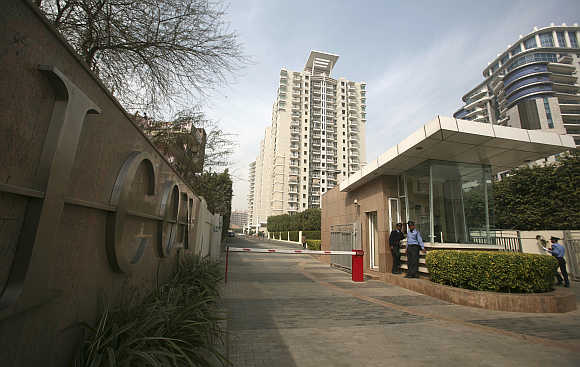 Private security guards stand at the entrance to an apartment complex in Gurgaon.