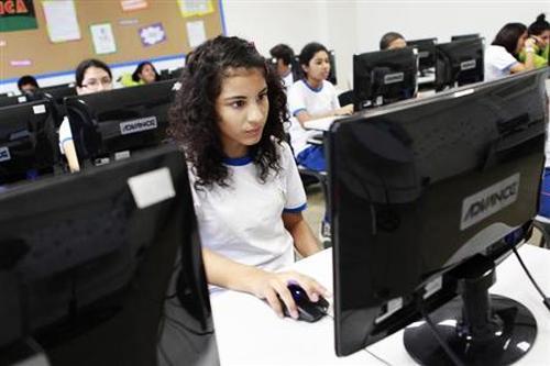 A girl surfing Internet in a class.