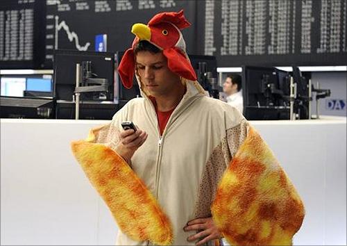 A stock trader dressed as a chicken stands on the trading floor at the German stock exchange in Frankfurt.