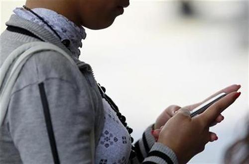 A woman uses her mobile phone.