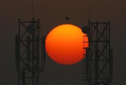 Sun rises over the telecommunication towers in New Delhi.