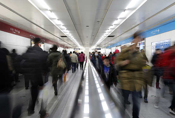 Passengers walk inside a subway station in Beijing, China.