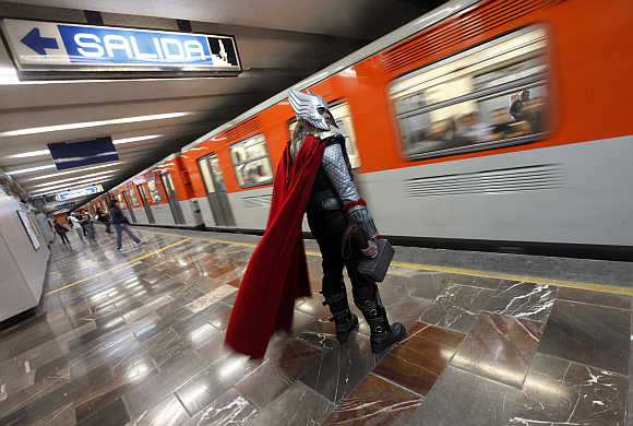 Ruben Oviedo, 40, dressed as comics superhero Thor, waits for the subway in Mexico City, Mexico.