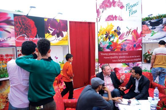 A marketing agent for international breeders puts up a stall at the flower show in Sikkim.