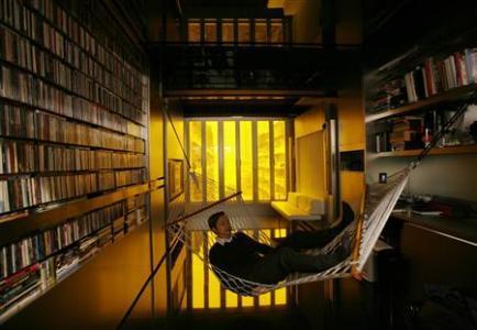 Architect Gary Chang rests in a hammock inside his 32-square-metre apartment in Hong Kong.