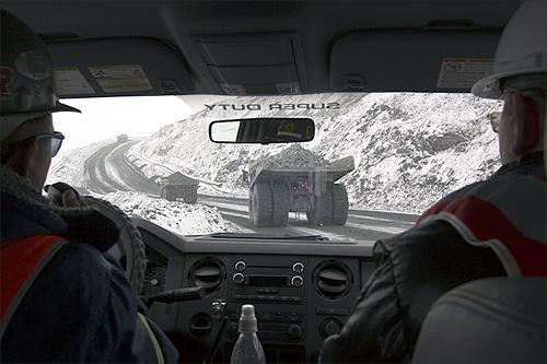 Dump trucks are seen through a windshield of another vehicle at Kumtor open pit gold mine in the Tien Shan mountains, some 350 kilometres (218 miles) southeast of the capital Bishkek near the Chinese border.