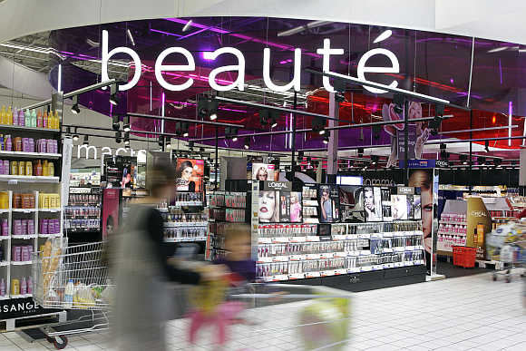 A shopper pushes a trolley near the beauty products section inside the Carrefour Planet in Lyon, France.