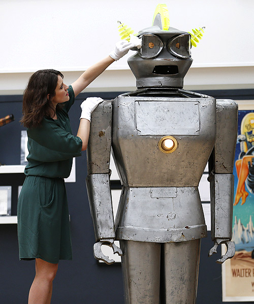 A Christie's employee poses with Cygan, a giant robot made by Italian engineer Piero Fiorito in 1957, at Christie's in London.