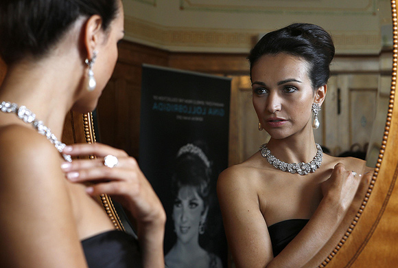 A model wears a diamond necklace/bracelet by Bulgari (1954) a natural pearl and diamond pendant earrings(1962) and a diamond ring (1962) during an auction preview at Sotheby's in Geneva.