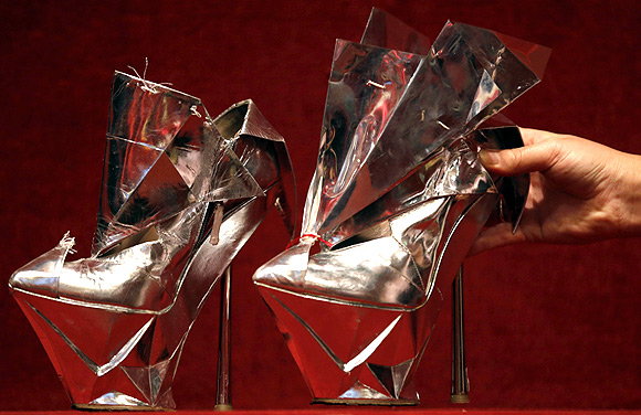 An assistant displays Platform shoes owned by singer Lady Gaga at the Hotel Drouot auction house in Paris.