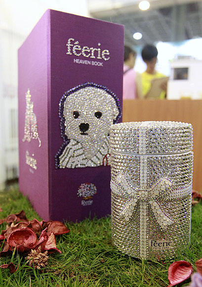 A pet urn (R) decorated with crystal and a book-shaped casket are seen at the 2013 Taipei Pet Show at Nangang Exhibition Hall in Taipei.