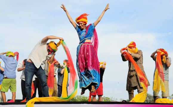 A tourist celebrates after finishing first in a turban tying competition held as part of the celebrations of Holi in Jaipur.