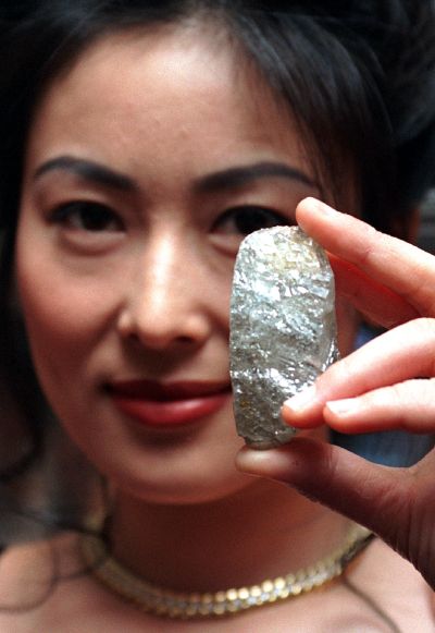A model displays the Sefadu diamond, the world's largest uncut diamond in existence today.