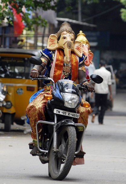 A man wearing an elephant mask on a bike in Chennai. 