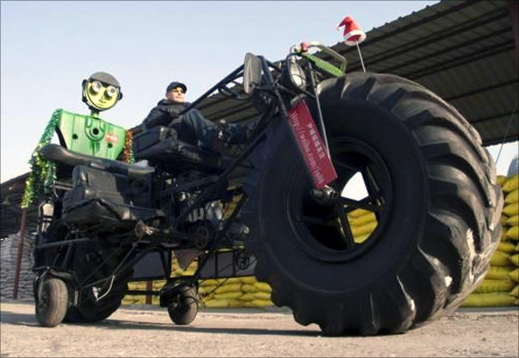 Zhang Yali, 49, tests a giant bicycle designed and made by him and his friends outside a rented warehouse in Jilin, Jilin province, China.