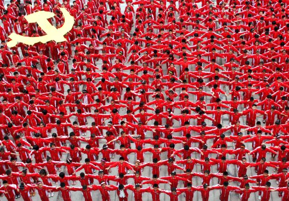 Students in school uniforms link their arms to form the flag of the Communist Party of China, in celebration of the party's upcoming 90th anniversary.