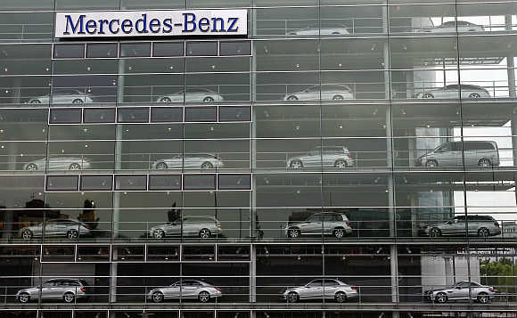 Mercedes-Benz cars are displayed in the windows of a dealership of German car manufacturer Daimler in Munich, Germany.