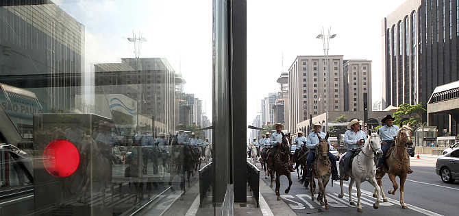People ride horses along a main avenue in the financial centre of Sao Paulo during World Car Free Day in Brazil.