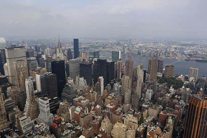 A view of Empire State Building, Chrysler building, East River and burough of Queens in New York.