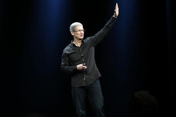 Apple Inc. CEO Tim Cook waves to the crowd during the Apple Worldwide Developers Conference (WWDC) 2013 in San Francisco, California.