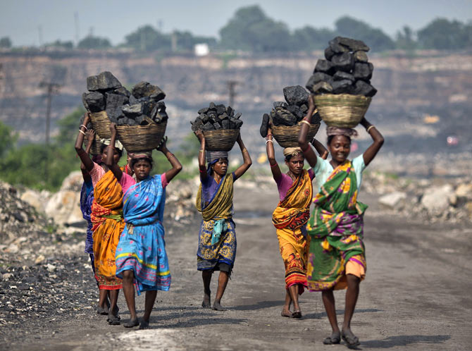 Women carry coal taken from an open cast coal field in Dhanbad district, Jharkhand.