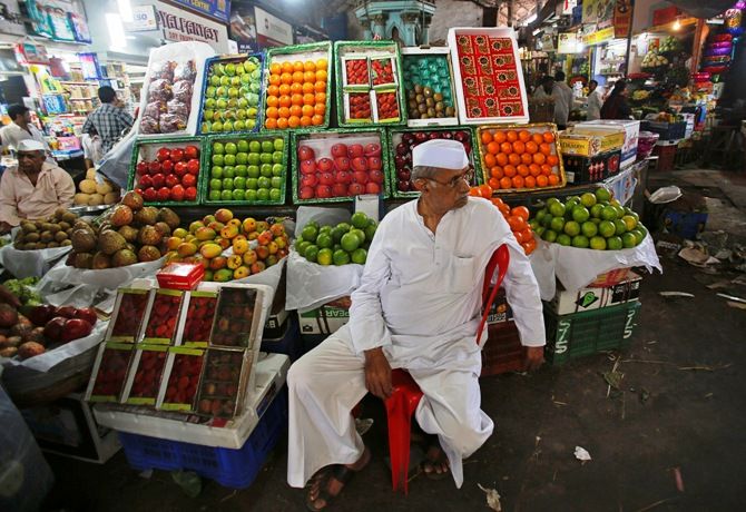 A fruit seller waits for customers at his stall at a wholesale market in Mumbai.