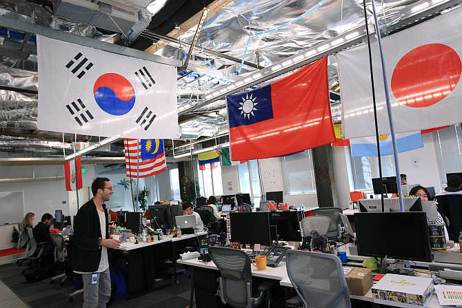 Employees work in the international user operations area at the headquarters of Facebook in Menlo Park, California.