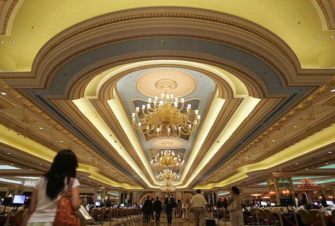 Visitors walk in the casino at the Venetian in Macau.