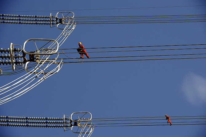 Employees work on pylons in Anji county, Zhejiang province, China.