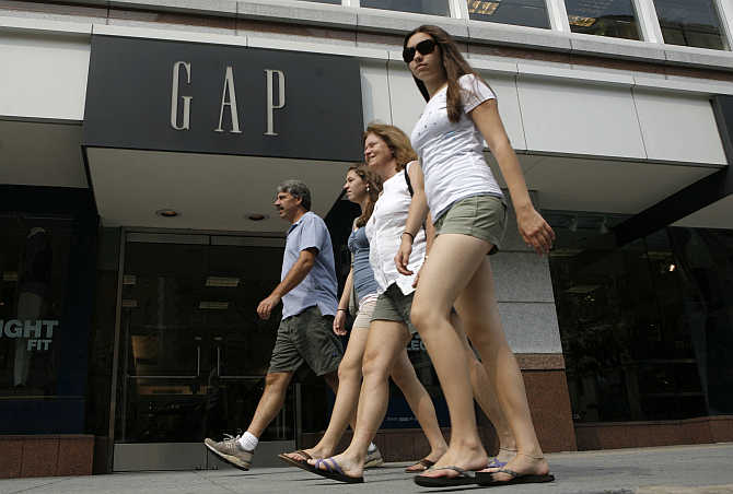 Pedestrians pass by a Gap clothing store in Washington.