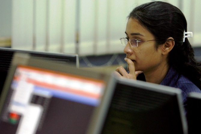 A broker looks at her computer terminal at a stock brokerage firm in Mumbai.
