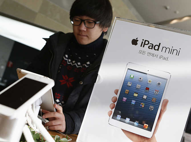 A student tries iPad mini at an electronics store in central Seoul, South Korea.