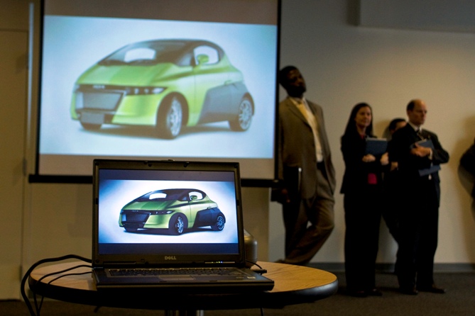 A video of the NXR, an electric vehicle made by India's Reva Electric Car Company, LTD, is displayed at a news conference in Syracuse, New York.