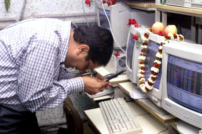 A The file photograph shows a broker worship his on-line trading computer at the Calcutta stock exchange.