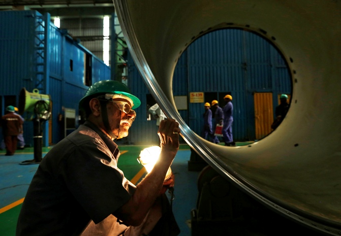 An employee works on the production line inside the heavy electrical manufacturing unit of Larsen & Turbo in Mumbai.