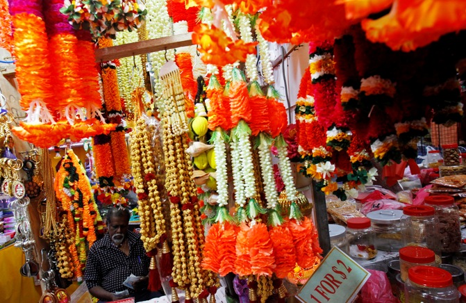 A vendor sells festive flowers.