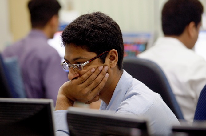 A trader looks on while trading at a stock brokerage in Mumbai.