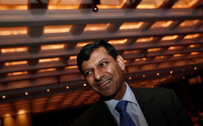 Reserve Bank of India Governor Raghuram Rajan smiles as he arrives to attend Delhi Economics Conclave 2013 in New Delhi.