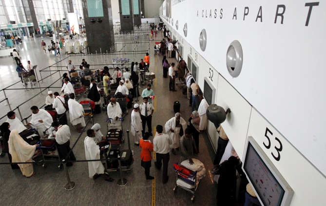 Passengers wait at the check-in hall at Bengaluru International Airport in Bengaluru.