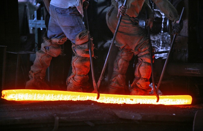 Labourers work inside an iron factory on the outskirts of Jammu.