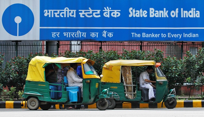 Autorickshaws wait in front of the head office of State Bank of India in New Delhi.