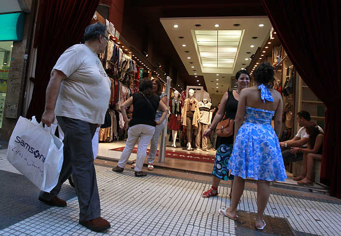 A man walks past a clothing store in Buenos Aires, Argentina.