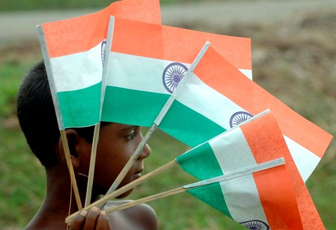 A boy sells Indian flags