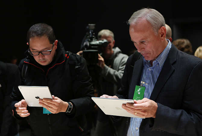 Members of the media look at the iPad Air during an Apple event in San Francisco, California.