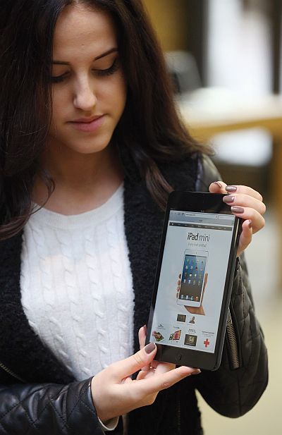 A woman holds a new 'iPad mini' on the morning of the tablet's launch in the Apple Store in Covent Garden, London.