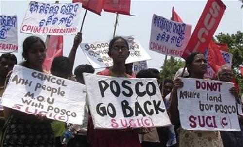 Villagers hold placards during a protest in Orissa.