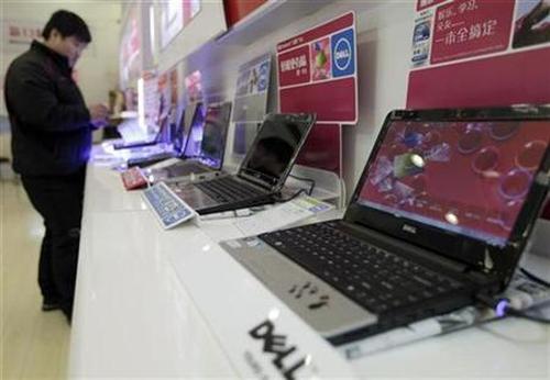 A customer looks at laptops at a Dell.