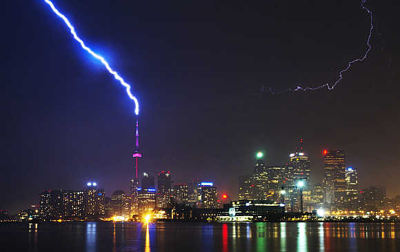 Lightning strikes the CN Tower during a thunderstorm in Toronto, Canada.