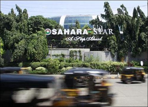 Auto-rickshaws move past a Sahara Star hotel in Mumbai.