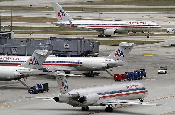 American Airlines planes sit at their gates while others taxi for arrival and departure at O'Hare International airport in Chicago, United States.